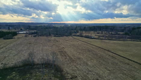 Countryside-Plains-With-Sunrays-Amidst-Cloudscape-During-Sunrise