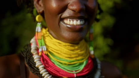 african woman wears colorful beaded necklaces and earrings