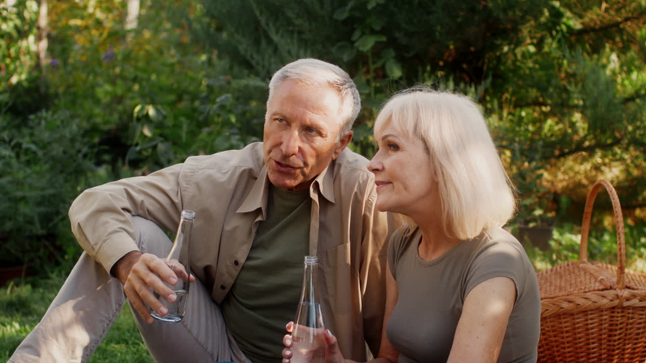 Elderly Couple Enjoying a Picnic in the Garden
