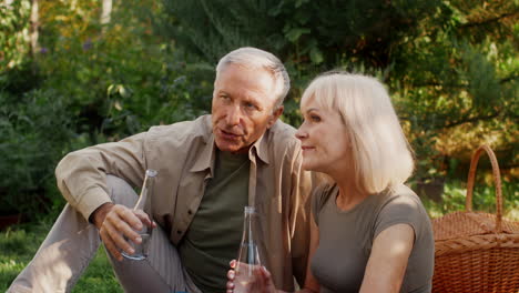 elderly couple enjoying a picnic in the garden