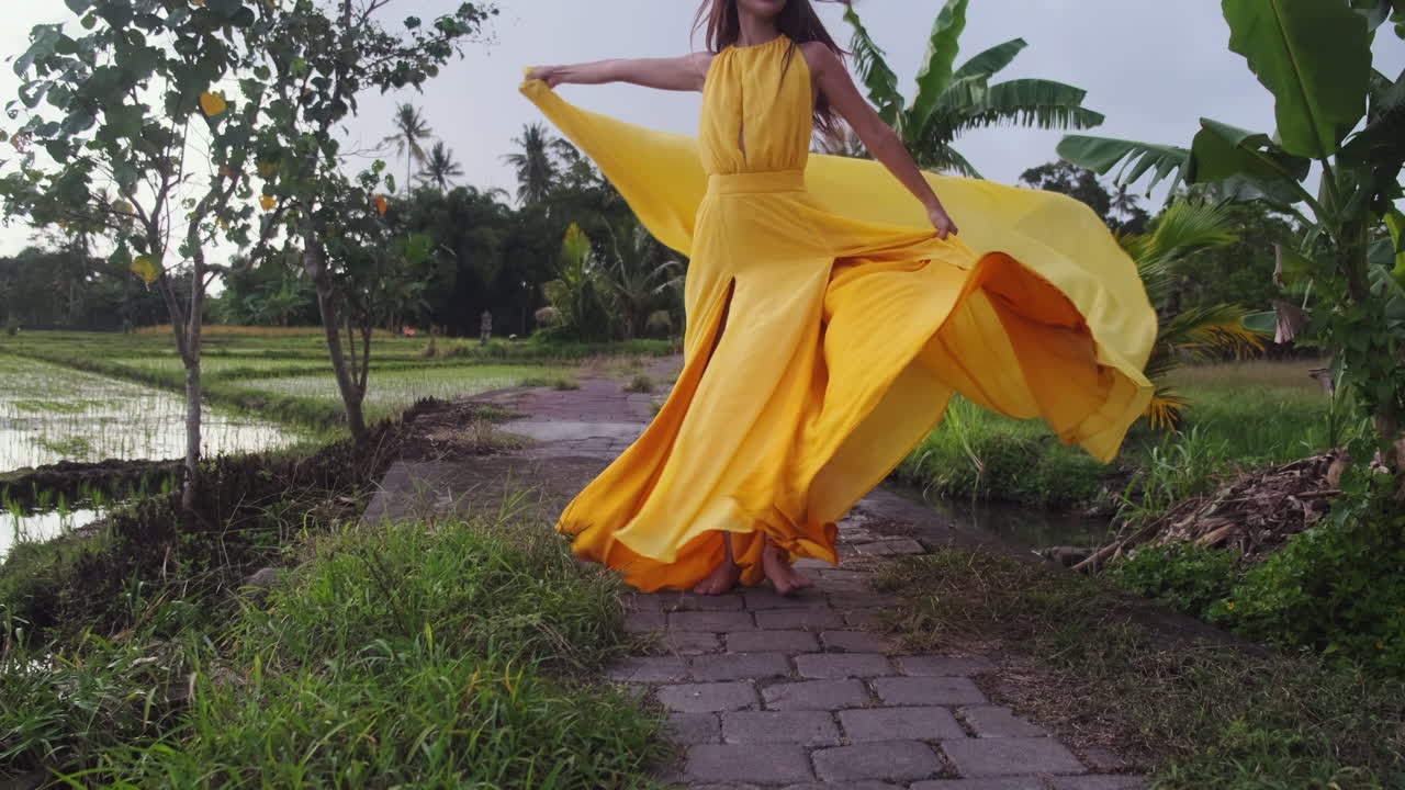 Woman in a Yellow Dress in a Rice Paddy