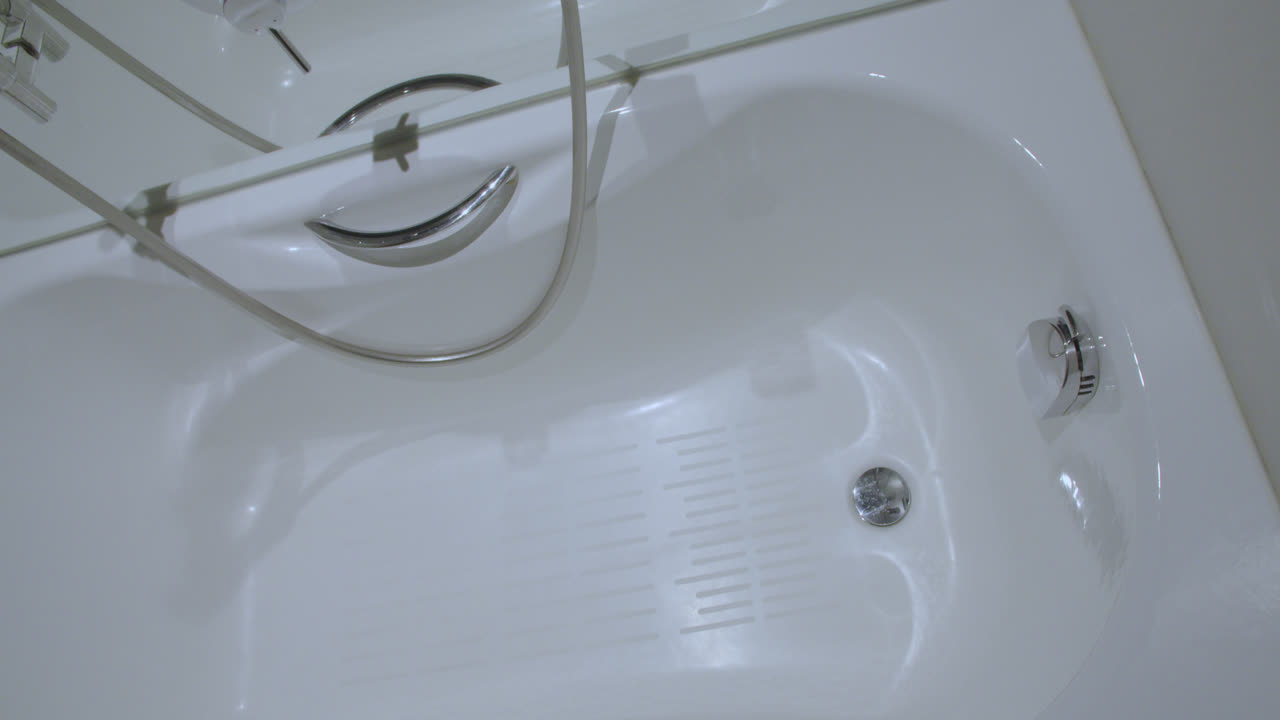 Beautiful slow motion overhead shot of the jacuzzi inside a luxury hotel white room bathroom in Spain. 4K