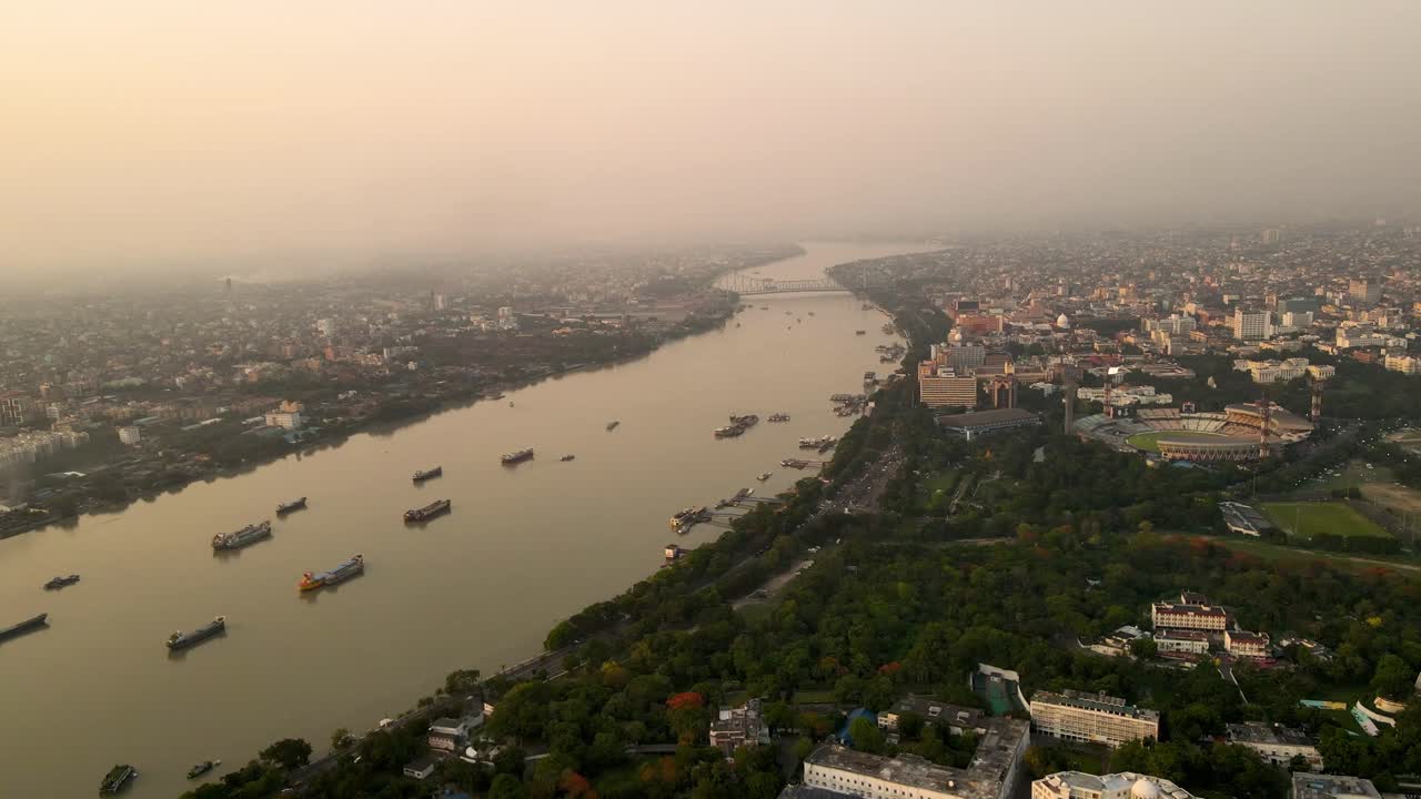 Aerial drone shot of Vidyasagar Bridge during sunset, capturing the tranquil Hooghly River below.