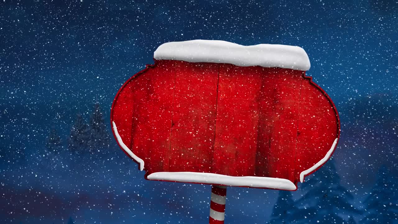 Snow falling over snow covered red sign post against blue background