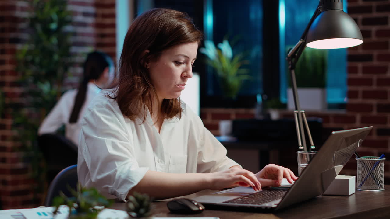 Worker typing on keyboard, writing financial business documents on laptop