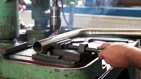 Drilling machine drills through a steel pipe