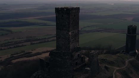 Crumbling-hilltop-medieval-castle-tower-ruins,-drone-aerial-view,-Czech-Republic