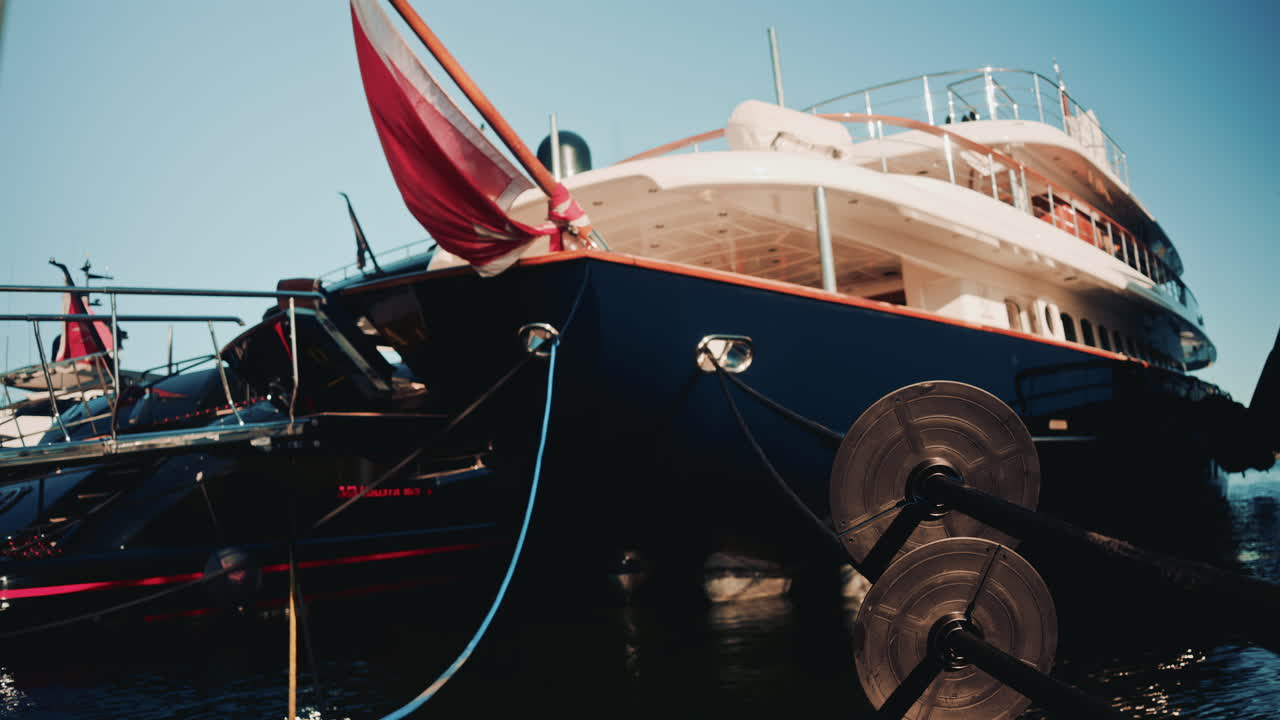 Cannes, France - November 18, 2025: Close up of thick mooring ropes attached to a sleek luxury yacht