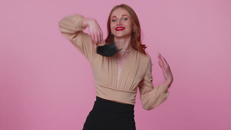 young smiling woman happily taking off medical mask and throws it away celebrating coronavirus end