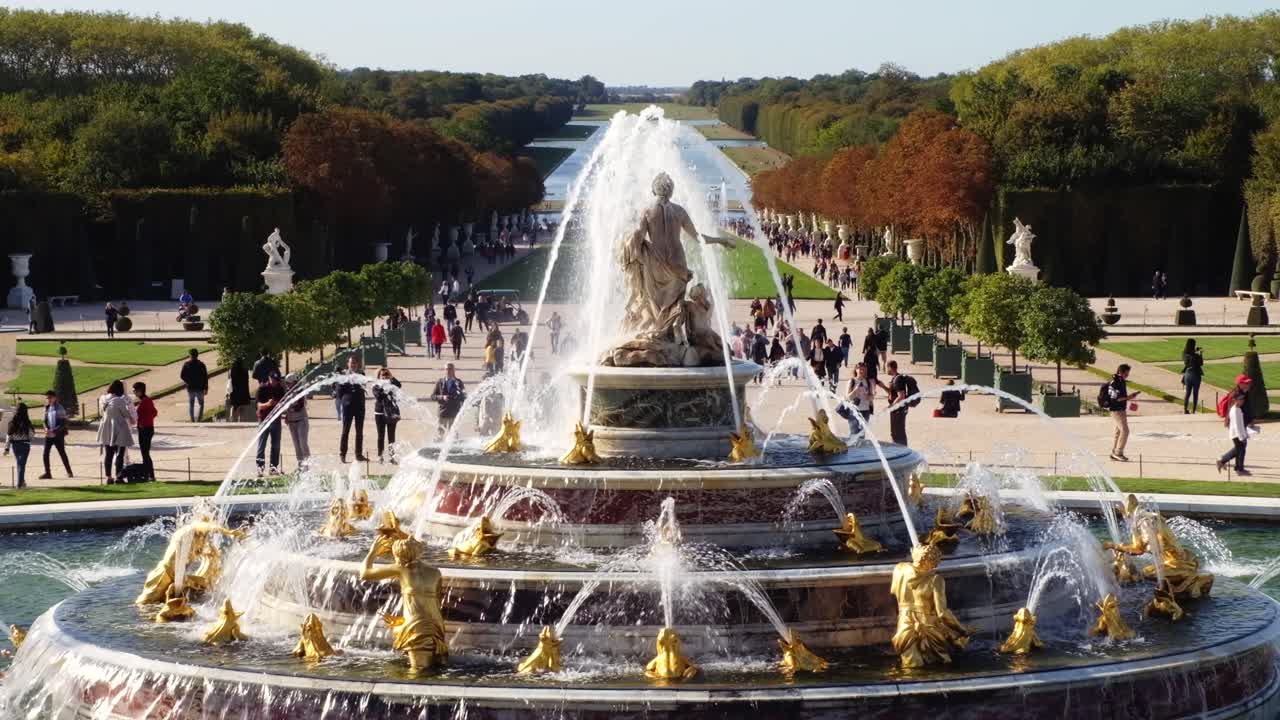Versailles, France - April 21, 2021: People walking through the Gardens of Versailles in daylight