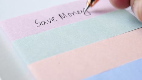 writing financial goals on sticky notes