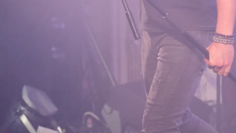 emotional little boy is singing into a microphone like a rock musician.