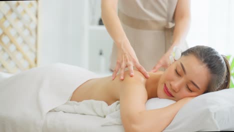 woman receiving a massage at the spa