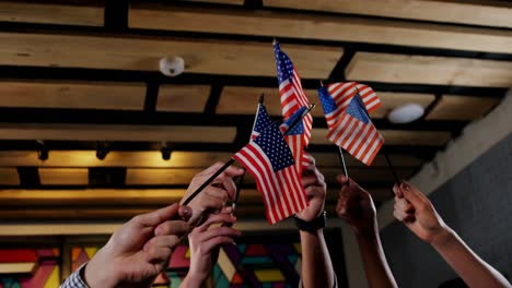 group of friends waving american flag