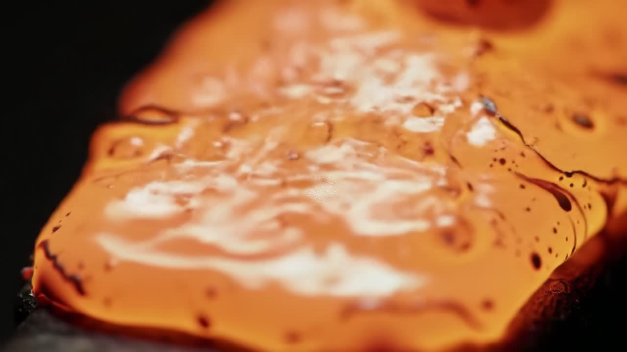 Visually Captivating Transition: The Intriguing Flow and Transformation of Vivid Colors in a Macro Exploration of Liquid Surfaces