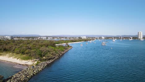 man made sand island to provide safe harbour for marine boats close to an urban city