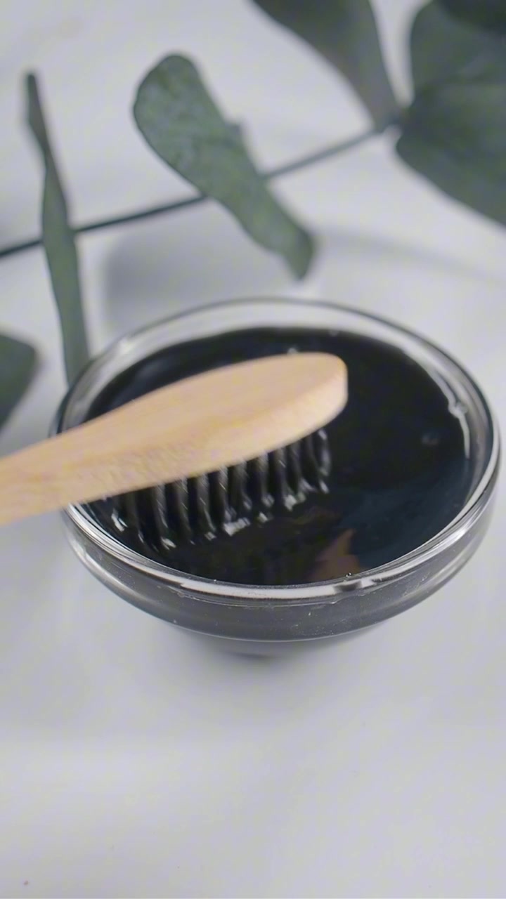 Bamboo Toothbrush Dipped in Black Charcoal Toothpaste