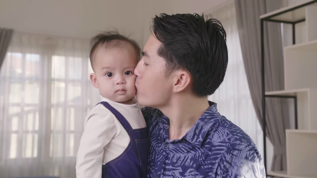 Asian Father Holding Son And Kiss