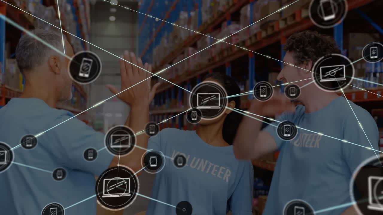 Animation of icons connecting with lines over diverse volunteers giving high five in warehouse
