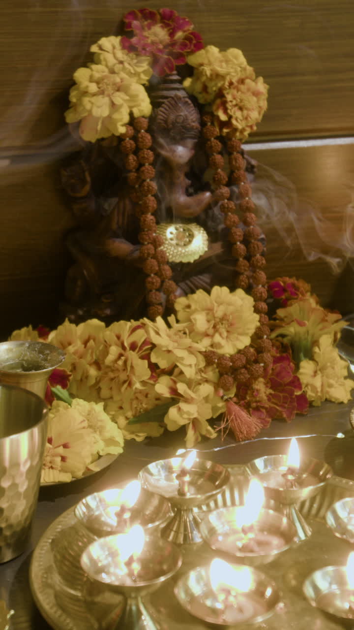 Ganesha Deity with Flowers and Candles