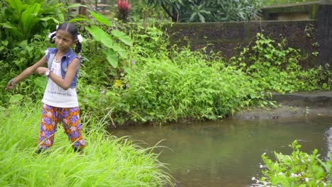 little girl fishing in pond green grass