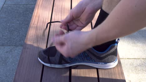 a runner is tying his shoes