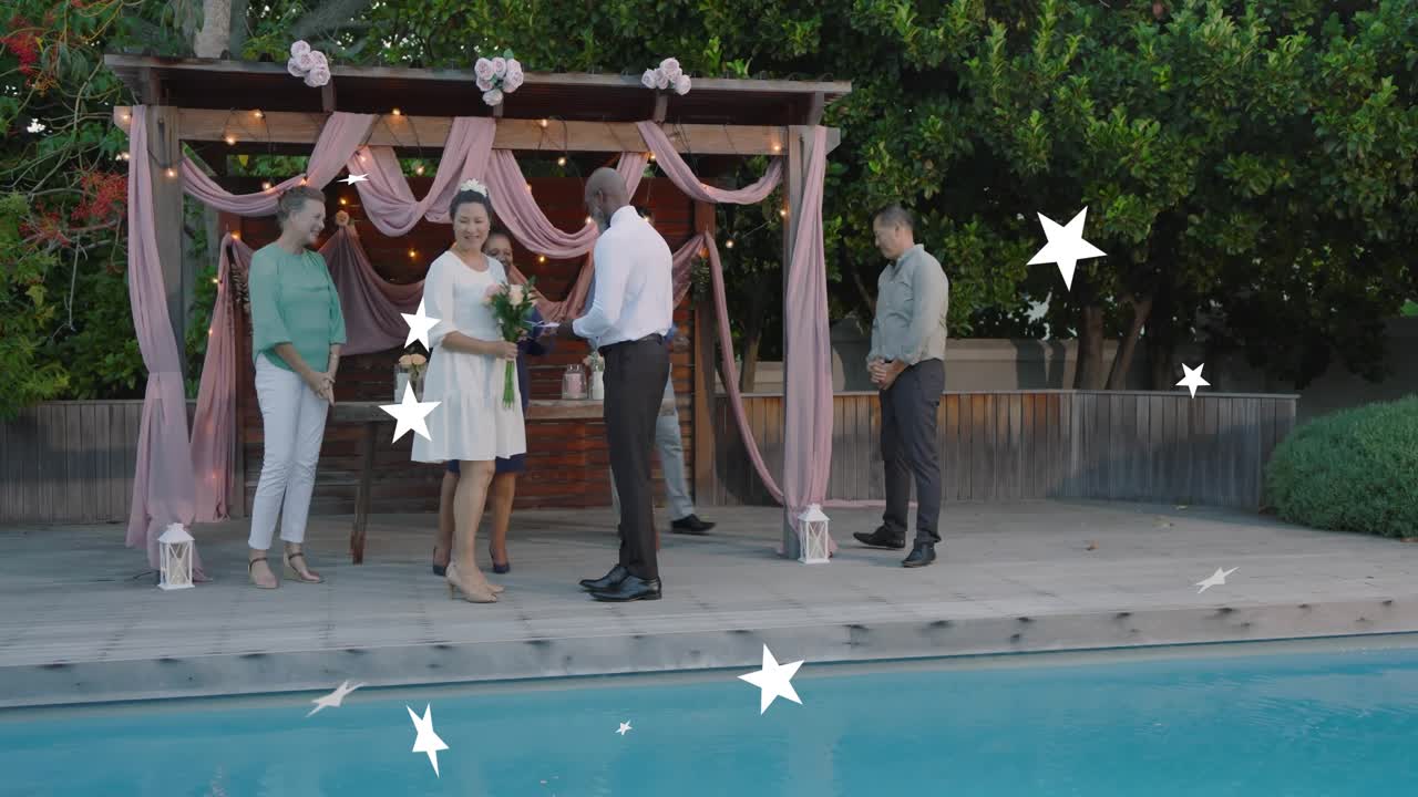 Officiant reading from book while couple exchanging vows on deck, animated stars floating over pool