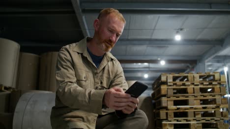 worker using a smartphone in a warehouse