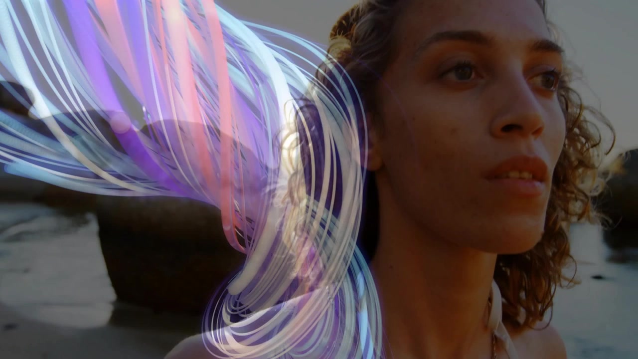 Woman on rocks gazing, purple glow appearing, growing into ribbon overlapping face for tech art
