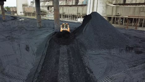 bulldozer moving coal. tractor on production of coal in a traditional manner