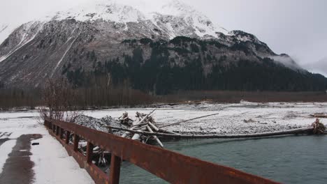 camera slowly pans over river and bridge in alaska