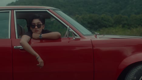 woman in a vintage red car