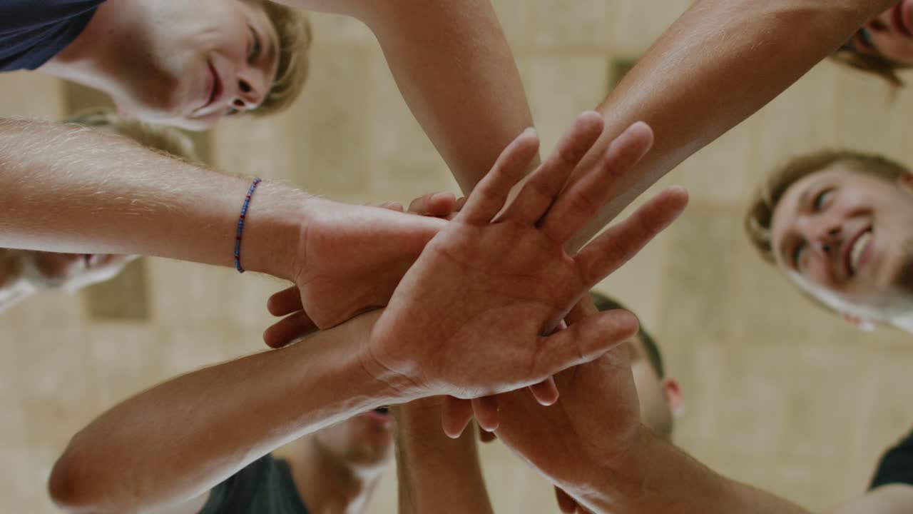 High team spirit of volleyball players - hands together in circle close up shot
