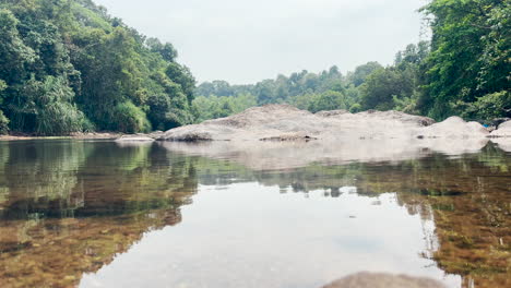 Bucolic-scene-of-river-and-tropical-vegetation-on-partly-cloudy-day