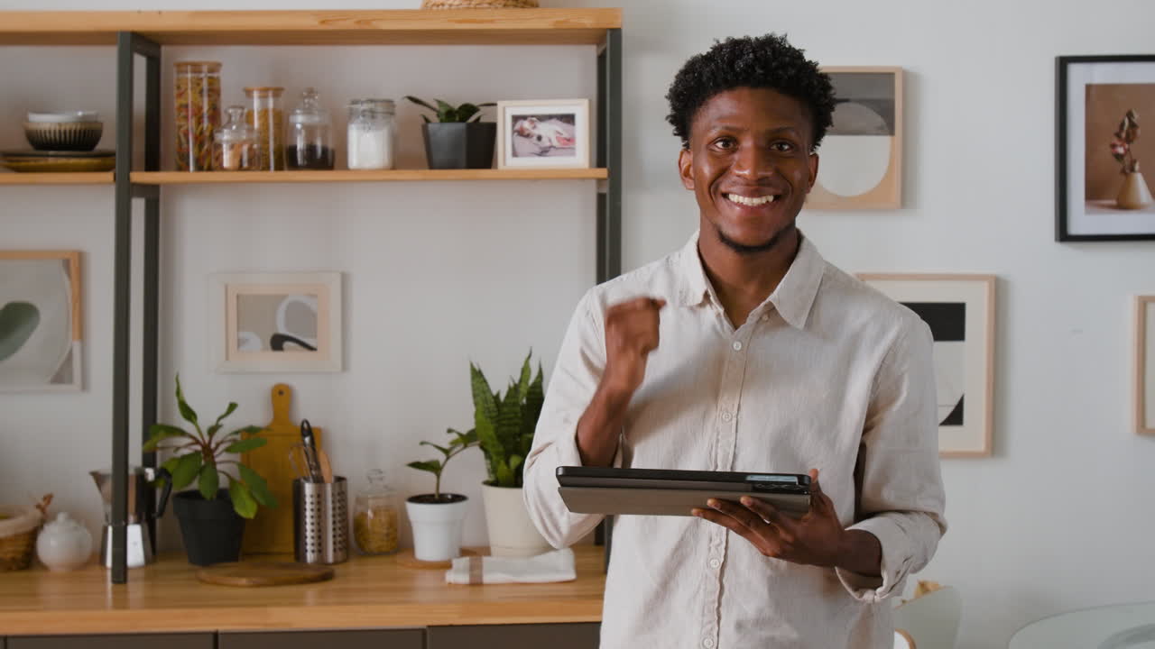 Man in kitchen with tablet