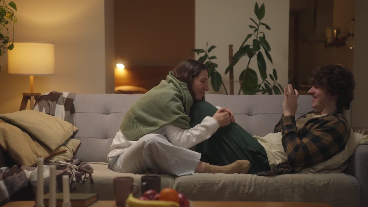 A Couple Relaxing Together on the Couch at Home