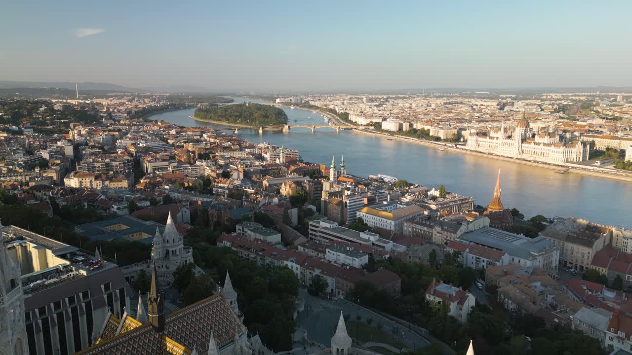Drone Flies Past Matthias Church, Fisherman's Bastion toward Danube River in Budapest at Sunset