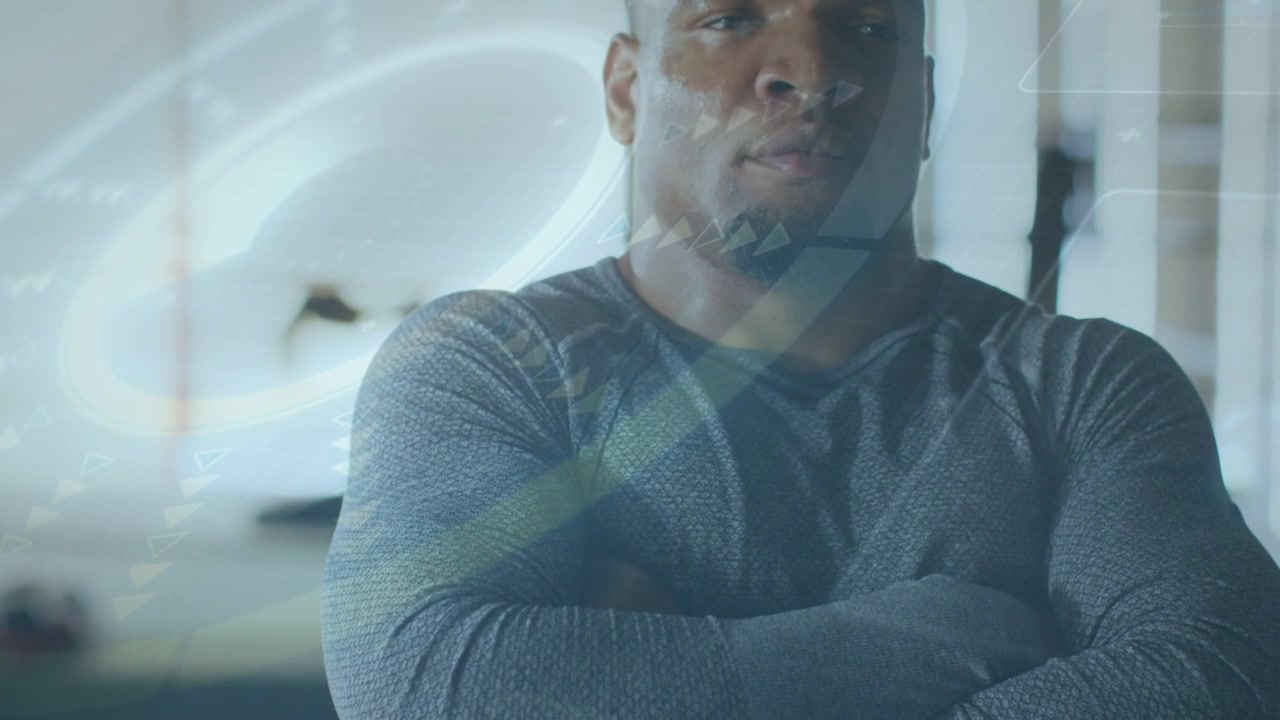 Man folding arms in tech studio, camera revealing face, overlay swirling introducing speaker