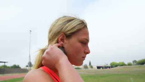 side view of caucasian female athlete getting ready for throw shot put throw at sports venue 4k