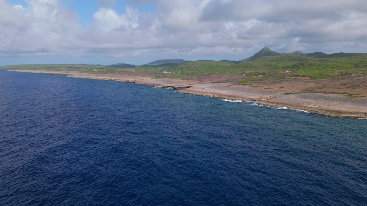 Aerial dolly over open ocean crystal clear blue waters