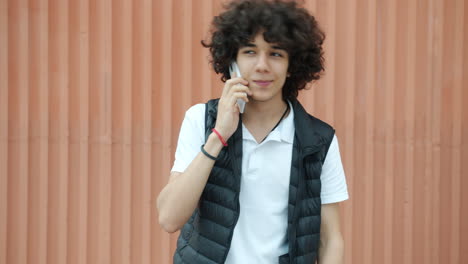 teenage boy talking on his phone