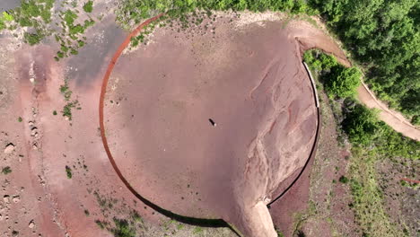 aerial top-down view of couple hugging in circled shaped volcanic area