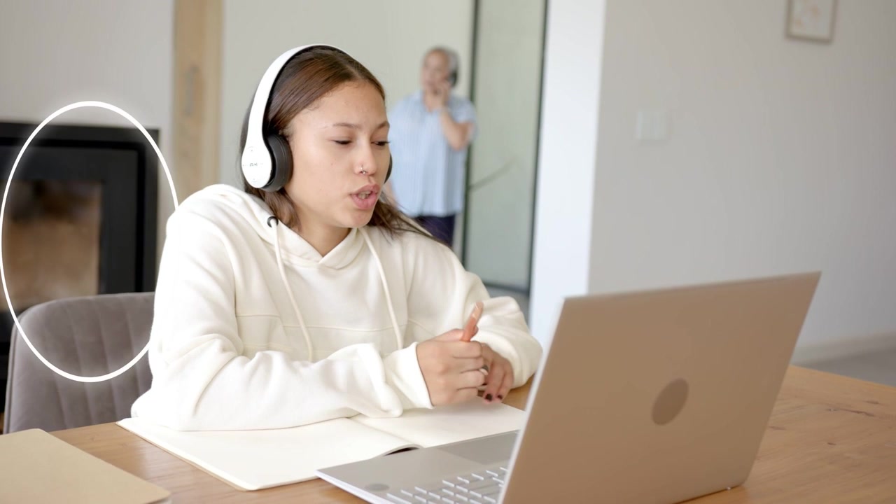 Teenager presenting to laptop, pointing and tapping as animated UI icons appearing for online class