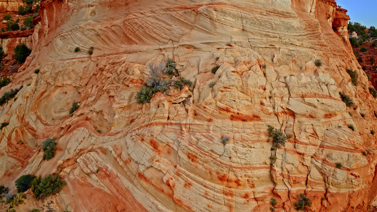 Drone shot flying over fascinating rock formations in the red rock canyon wall