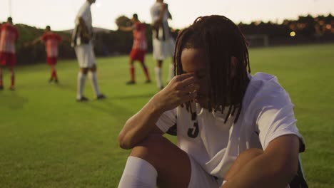 video of mad african american football player siting on field