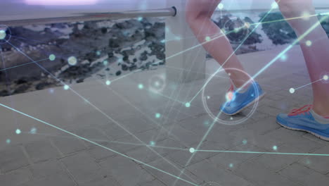 animación de líneas de red que conectan puntos, mujer caucásica haciendo ejercicio de estiramiento en el muelle en la playa