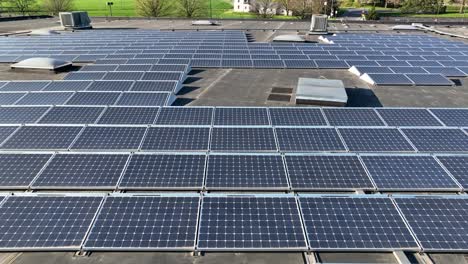 Close-aerial-view-of-solar-panel-installation-on-industrial-rooftop