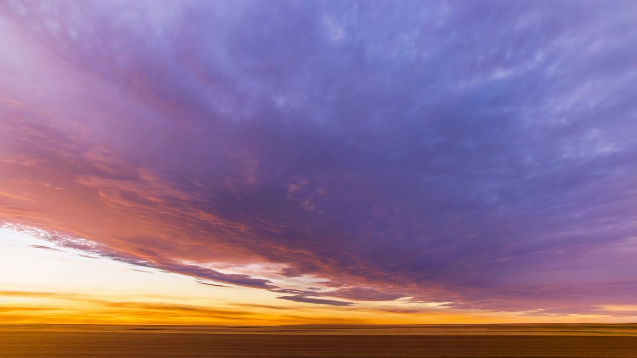 Sunset sky transitioning sunset, in sky, with clouds, horizon, with air, clouds texture, from a aerial perspective, with blue, orange accents, and serene and tranquil mood, clear detail.