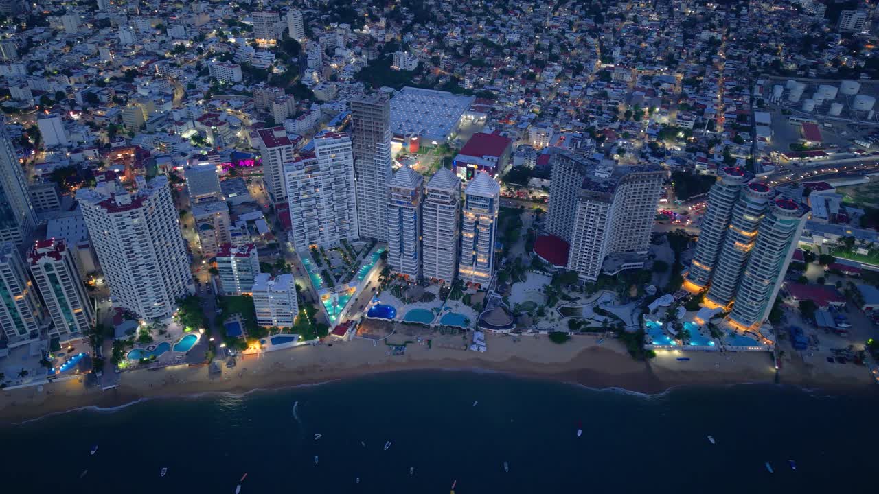 Scenic nighttime drone view of Acapulco’s resort area