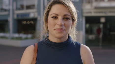 slow motion portrait of successful blonde business woman smiling confident relaxed in city street